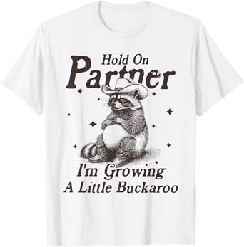 Hold On Partner I'm Growing A Little Buckaroo Funny Raccoon T-Shirt